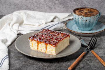 Trilece cake slice on dark background. Milk and caramel cake. Bakery products. Mexican sweets....