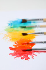 Obraz premium Paint brushes with paints on white background