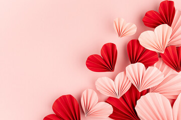 Valentines day, hearts love background for marriage celebration - many beautiful pink and red paper ribbed hearts in origami style fly on pastel pink color as sideways border, copy space, top view.