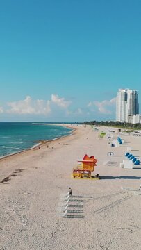 Miami South Beach Florida. Beach with colorful chairs and umbrellas and lifeguard hut on a sunny day in Florida