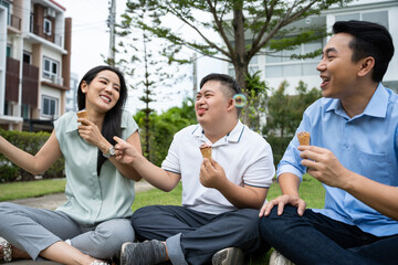 Asian attractive family, parents playing with young son in the garden. 