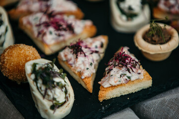 Delicious appetizers are served on a decorated table during a wedding event.
