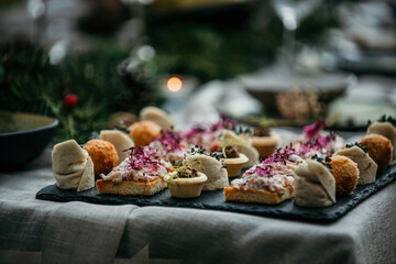 Delicious appetizers are served on a decorated table during a wedding event.