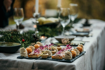 Delicious appetizers are served on a decorated table during a wedding event.