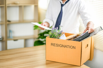 Resignation letter and cardboard box on the table, termination and resignation, job resignation. Great resignation.