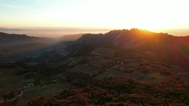 Aerial view of les Dentelles de Montmirail in front of the Mont Ventoux in the french alps at sunset