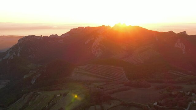 Aerial view of les Dentelles de Montmirail in front of the Mont Ventoux in the french alps at sunset