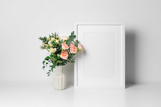 Blank vertical artwork frame mockup with roses flowers bouquet