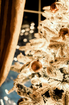 Christmas tree ornaments shining in the dark. Cozy winter night