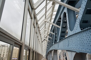 Obraz premium iron and glass structures. riveted metal supports and large windows. a beautiful modern building of a closed pedestrian bridge.