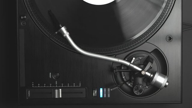 Dj record player. Turntable deck plays vinyl disc with music in vertical video clip
