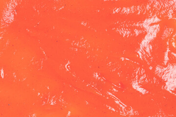 Orange sauce splashes as background.