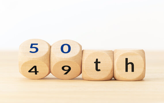 Turning 50 years old concept. Text on wooden blocks and changing dices