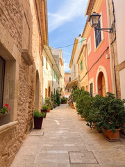 walking in the narrow streets of the old town of alcudia, spain