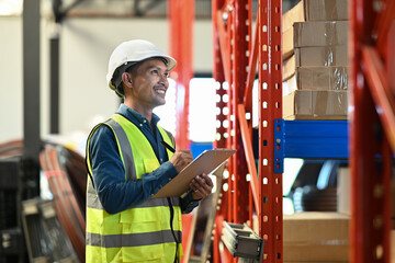 Warehouse managers standing between retail warehouse full of shelves and checking supply export shipment