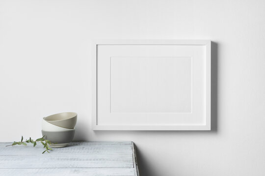 Blank landscape picture frame mockup in white room interior
