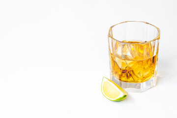 Glass of whiskey or brandy with ice. Strong alcohol background