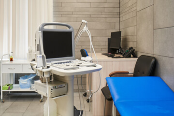 blue couch and ultrasound machine with monitor
