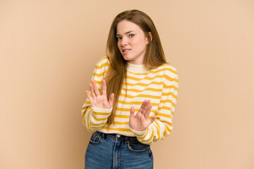 Young redhead woman cut out isolated rejecting someone showing a gesture of disgust.