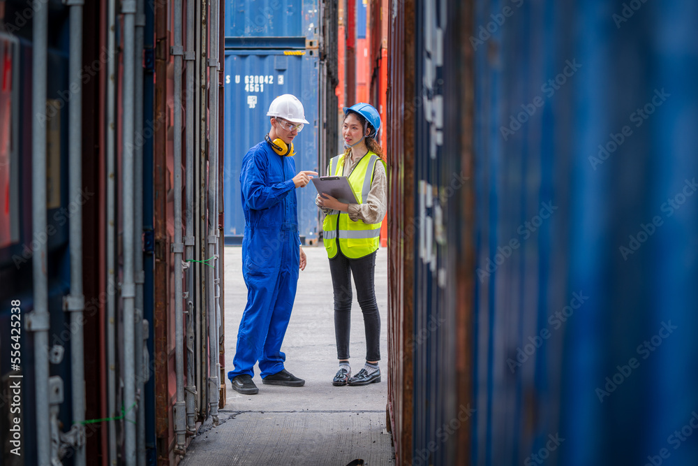 Poster Manager and worker working checking stock into container for loading,Logistic and business export.