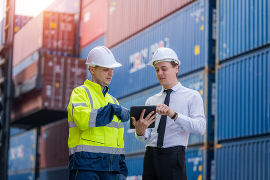 Businessman and Technicians or engineer work at Container cargo site check up goods in container.