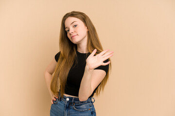 Young redhead woman cut out isolated rejecting someone showing a gesture of disgust.