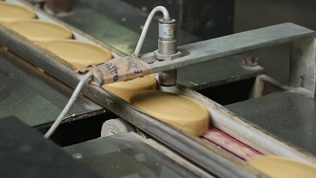 Closeup of ready soaps moving on conveyor belt for packaging
