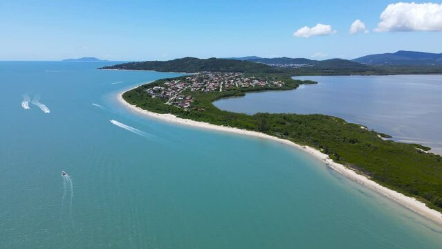 Aerial drone scene of houses on the beach seen from above high standard houses facing the sea in florianopolis daniela beach with turquoise blue sea and lots of nature daniela beach florianopolis