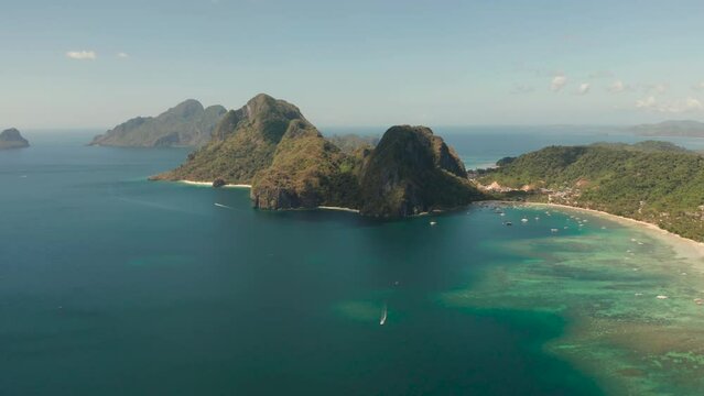 Aerial view bay with lagoon and turquoise water on a tropical island against the backdrop of the mountains. Corong corong beach, El Nido, Palawan, Philippines. Summer and travel vacation concept