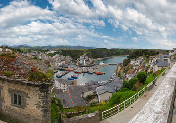Fototapeta na wymiar Evening Luarca cityscape (top view) with colorful boats in fishing port, Asturias, Spain.