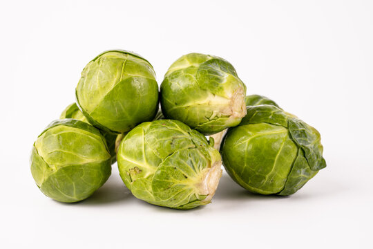 raw uncooked Brussel sprouts isolated on a white background