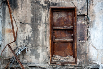 door and wall of a destroyed and burnt house in Ukraine