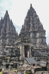 Naklejka premium vertical tourist girl posing at prambanan temple, yogyakarta indonesia.