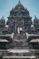 Naklejka premium couple of tourists at prambanan temple, yogyakarta indonesia.