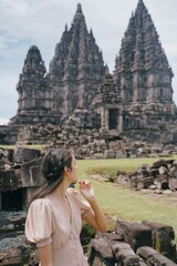 Fototapeta premium vertical model posing at prambanan temple, yogyakarta, indonesia