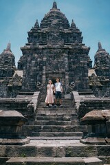 vertical couple of tourists at prambanan temple, yogyakarta indonesia.