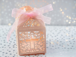 Paper gift box and bokeh. Cross-cut paper packaging, Souvenir box for sweets, dragees for the...