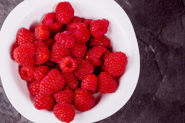 Close up of red raspberries on white background