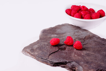 Close up of red raspberries on white background
