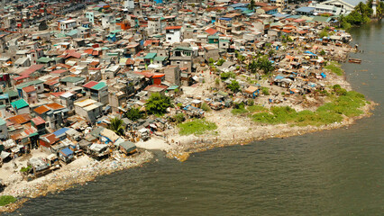 Slums in Manila near the port. River polluted with plastic and garbage. Manila, Philippines.