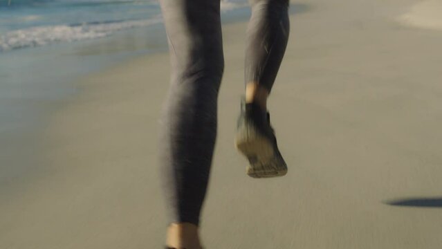 Legs, woman running and beach fitness workout for sports marathon motivation or training zoom. Runner, athlete female and cardio run on Cape Town ocean seaside for freedom, wellness and exercise