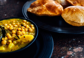 Puri bhaji the national breakfast dish of Indian cuisine. Authentic food in India. Fried puris and beans spicy sauce.