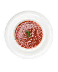 Cold tomato soup gazpacho with basil. Spanish and Portuguese cuisine. Dish is served on white plate. Vegetarian dish. Isolate on white background. Copy space. View from above.