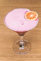 Alcoholic cocktail on wooden board