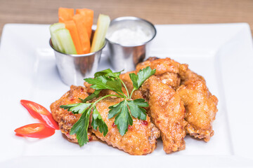 Restaurant dish - fried wings with carrot slices