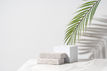 Empty podium for cosmetics beauty product presentation. Made with pumice stone on a bathroom table. Front view.