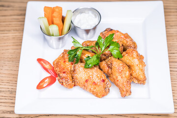 Restaurant dish - fried wings with carrot slices