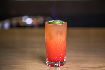 Alcoholic cocktail on wooden board