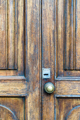 Fototapeta na wymiar Old vintage door. Antique wooden door background with lock and handle on architecture facade home. 