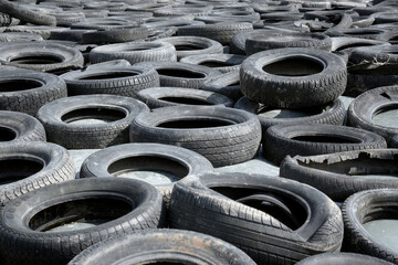 A bunch of old tires laying on the ground